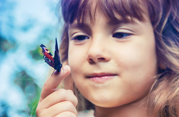 child with a butterfly in his hands. Selective focus.