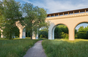 Fototapeta na wymiar Ancient aqueduct on a summer evening. Aqueduct in Rostokino in Moscow, Russia