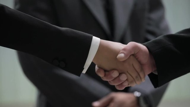 Close up shot of handshake in office