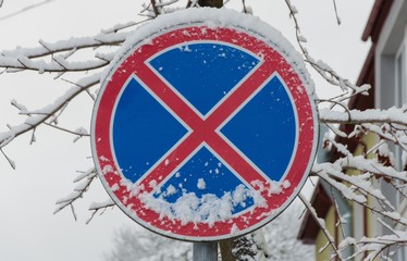 Snowy road sign in the winter afternoon