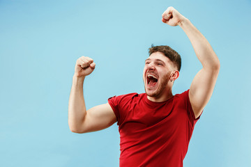 I won. Winning success happy man celebrating being a winner. Dynamic image of caucasian male model on blue studio background. Victory, delight concept. Human facial emotions concept. Trendy colors - Powered by Adobe