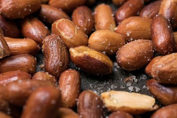 Roasted and salted peanuts with peel close-up
