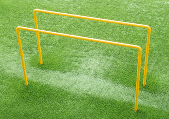 Parallel bars on an AstroTurf pitch used for exercise and fitness.