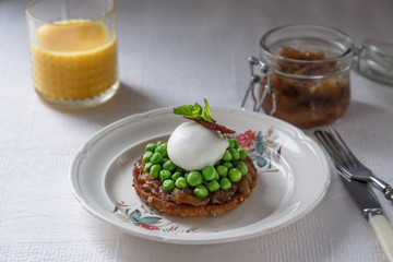 Healthy Breakfast with Wholemeal Bread Toast with Poached Egg and Peas. Orange Juice and onion jam on background