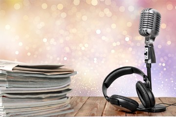 News and microphone on table.