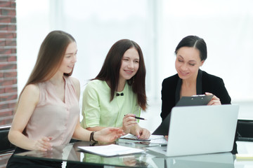 close up.three employees of the company work with documents at the table in the office