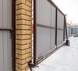 Retractable gate on the fence in winter