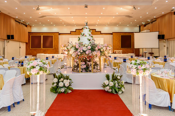 wedding cake with Decorated with flowers and Candlestick at marriage ceremony