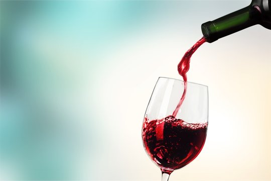 Red wine pouring in glass