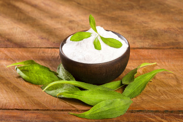 Natural sweetener in powder from stevia plant - Stevia rebaudiana. Top view