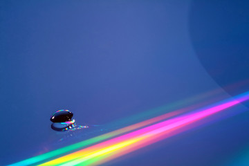 Water drop on a compact disc with refraction patterns