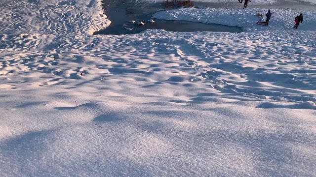 Frozen river covere by the snow. Sunset time. Winter