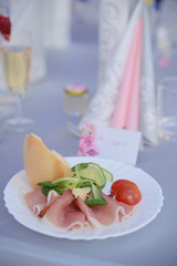 appetizer a ham and a beautiful table setting at a wedding
