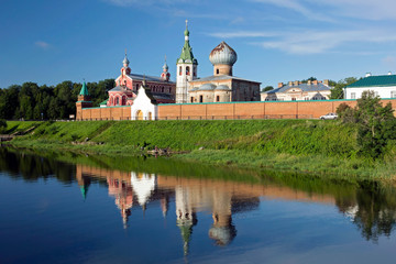Obraz premium View from the river to St. Nicholas monastery with its reflection in the water. Old Ladoga.