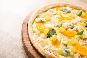 sweet pizza with banana, grapes and mint