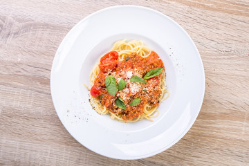 spaghetti bolognese with veal and basil leaves