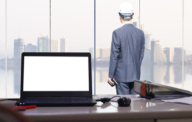 businessman is standing at office and  looking big city