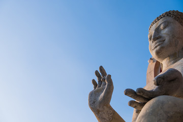 Rock Buddha statue with blue sky used for amulets of Buddhism religion. Buddhism is popular region in China Japan and south east Asia.copy space concept.