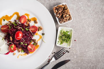 Vegetarian salad beetroot with tomato, nuts and peas