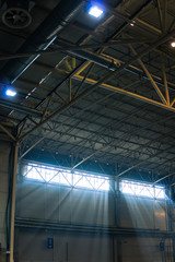 Interior of warehouse. large metal structures, ceiling. roof. concept production and installation of equipment for rooms, lighting, ventilation and windows for hangars, vertical photo