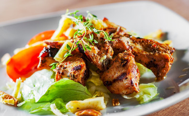 fried chicken breast piece fillet with vegetables salad on white plate