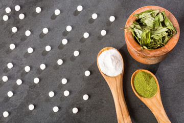 Pills, powder and leaves of stevia plant - Stevia rebaudiana. Sweetener