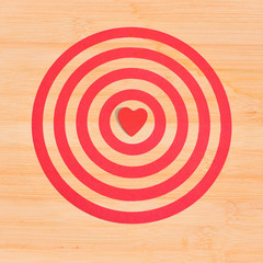 Red heart on dart board game on wood ,Valentine day concept.