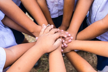 School children use hand-to-hand coordination to combine power in activities.
