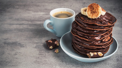 homemade pancakes with chocolate, nuts and coffee cup
