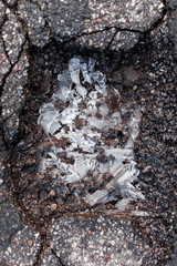 Ice pieces on concrete street in Winter