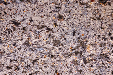The structure of an artificial gray stone with multi-colored splashes.