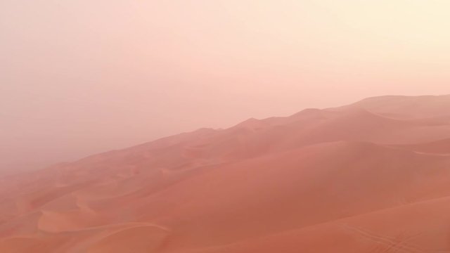 aerial view of massive sand dunes of Liwa desert in a early morning fog 