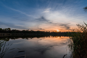 the river at sunset, the mirror surface of the water