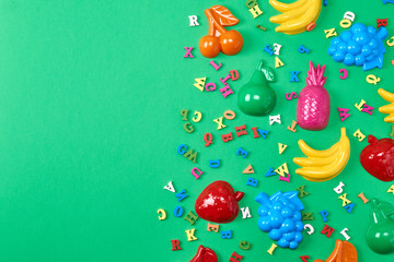 green background with childrens plastic toys