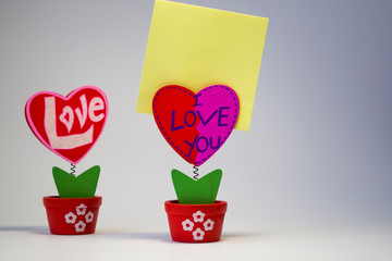 White. Wooden hearts with clothespegs for stickers on a spring. St. Valentine's Day. Blank space of day of an inscription.