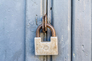 Closed front door with an old padlock.