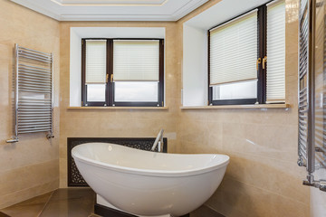 Stylish bathroom with rounded ceramic bath.