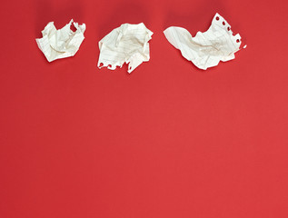 three crumpled white pieces of paper