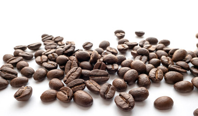 Roasted coffee beans on white background. Close-up.