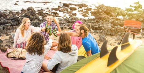 Friends backpackers having fun together at beach camping party - Happy friendship travel concept...