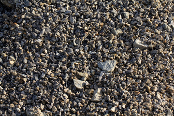 Stones crushed into smaller pieces. Stone chippings. Background of the stones.