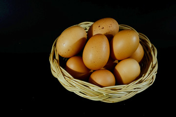 Eggs in wood basket and have space for write wording on black background, popular useful high protein food for making many kinds of food, suitable for children and growth age people, easy to cook