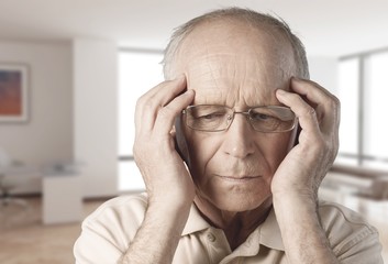 Portrait of a mature man holding his head in pain