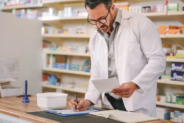 Wall murals Pharmacy Pharmacist writing prescription pharmacy counter
