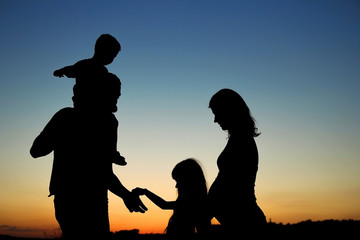 Fototapeta na wymiar silhouette of a happy family with children