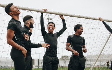 Group of footballers standing near the goalpost © Jacob Lund