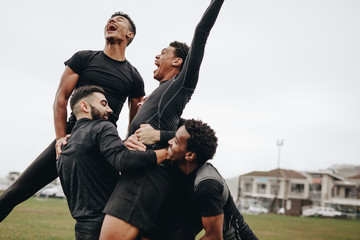Happy football players celebrating victory © Jacob Lund