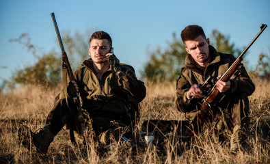 Hunters friends enjoy leisure. Rest for real men concept. Hunters with rifles relaxing in nature...
