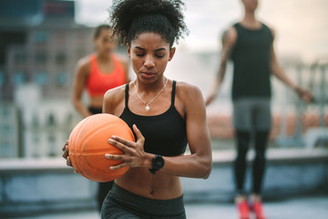 Portrait of athlete woman holding basketball