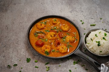 Shrimp in curry coconut sauce with rice in a bowl